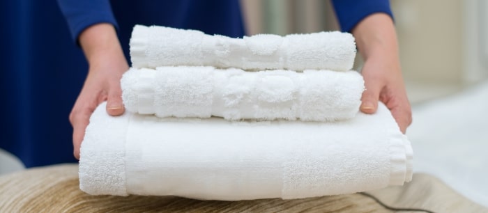 Woman Changing Hotel Room Towels Min